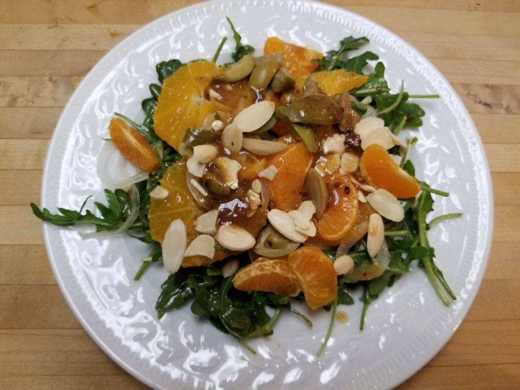 Citrus Salad over a bed of Arugula with a Date and Fig Balsamic Vinaigrette, Almonds, and Picholine Olives