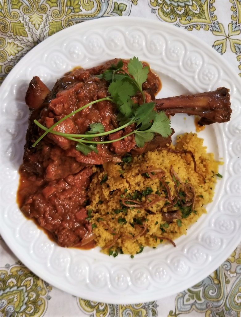 Moroccan Braised Lamb Shanks with Quince Served with Couscous with Apricots, Mint, Cilantro, Parsley and Fried Shallots 