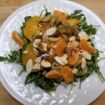 Citrus Salad over a Bed of Arugula with a Date and Fig Balsamic Vinaigrette, Almonds, and Picholine Olives